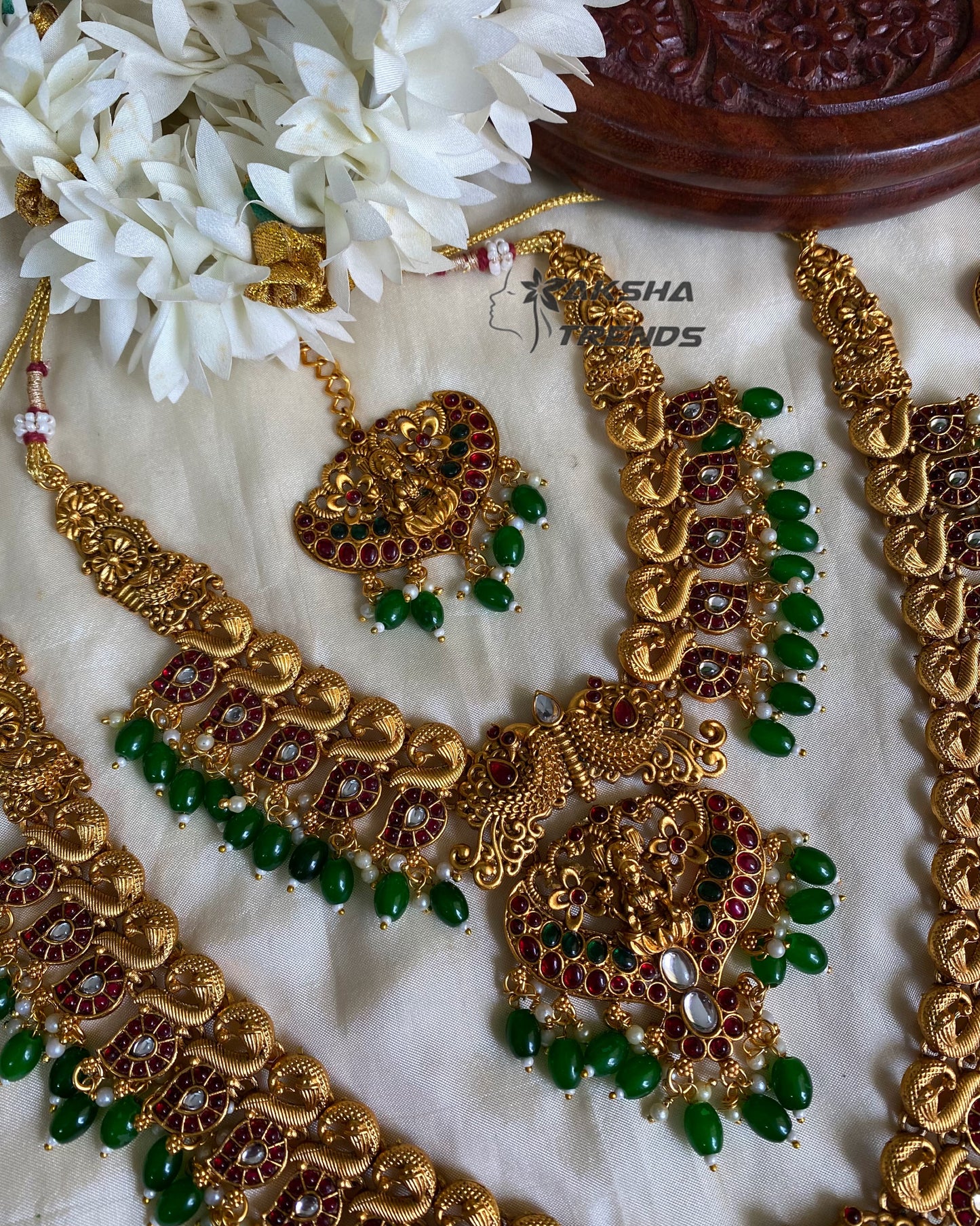 Grand peacock bridal combo with emerald beads Aksha Trends
