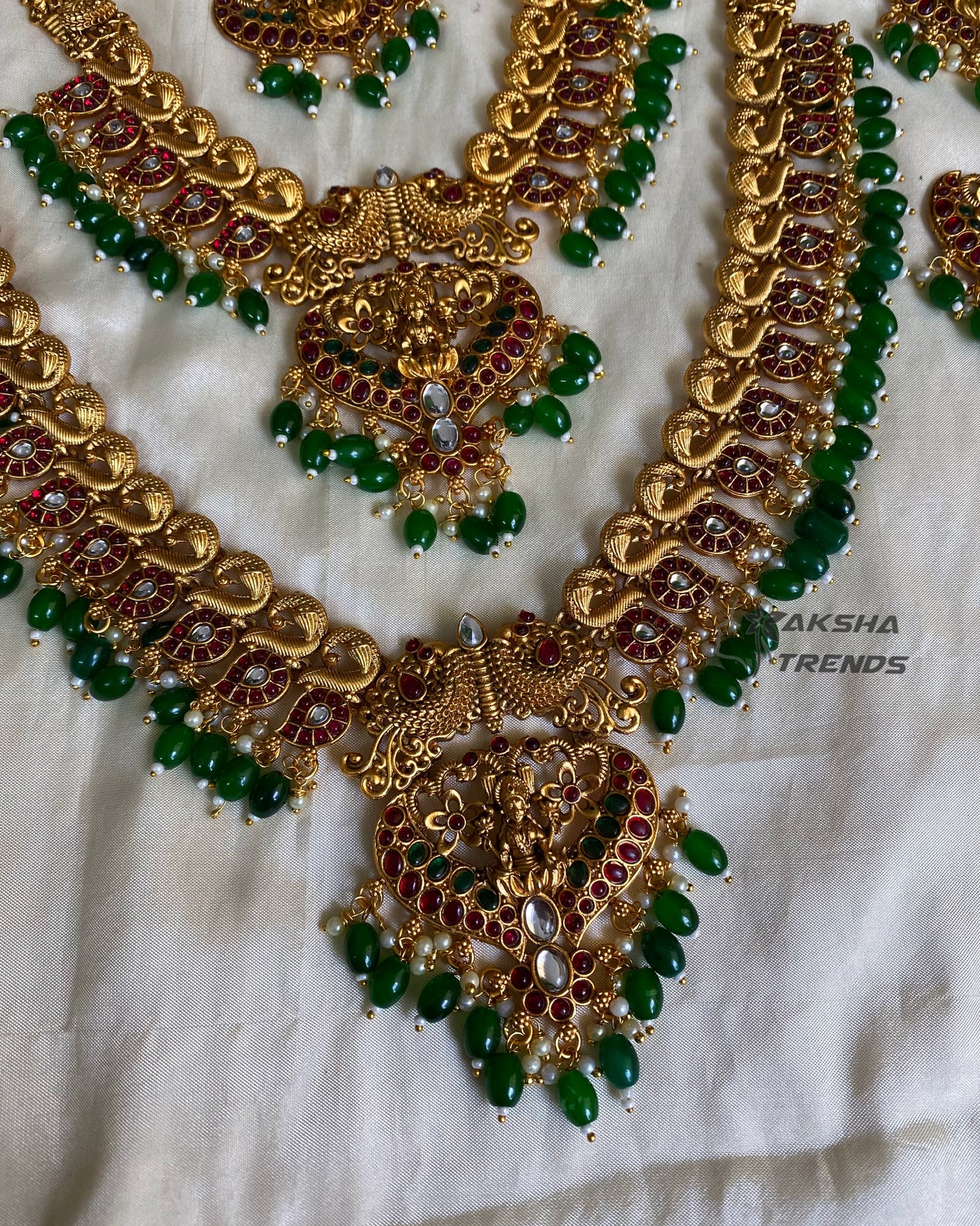 Grand peacock bridal combo with emerald beads Aksha Trends