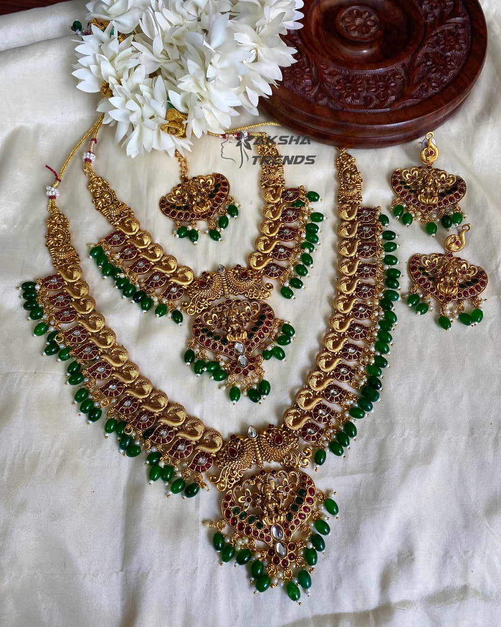 Grand peacock bridal combo with emerald beads Aksha Trends 